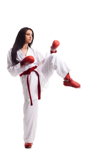 穿着和服 戴着红色手套 背对着白色背景 练习空手道腿踢的女孩 — 图库照片