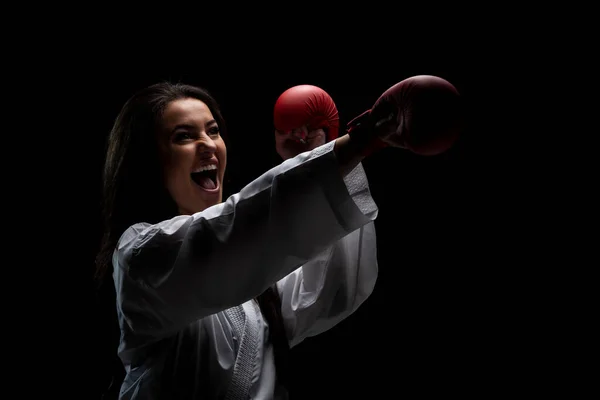 Chica Ejercitando Golpe Karate Gritando Contra Fondo Negro —  Fotos de Stock
