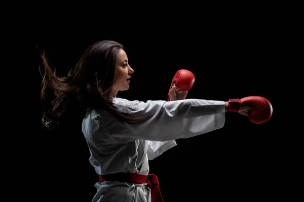 Girl Exercising Karate Punch Wearing Kimono Red Gloves Black Background — Zdjęcie stockowe