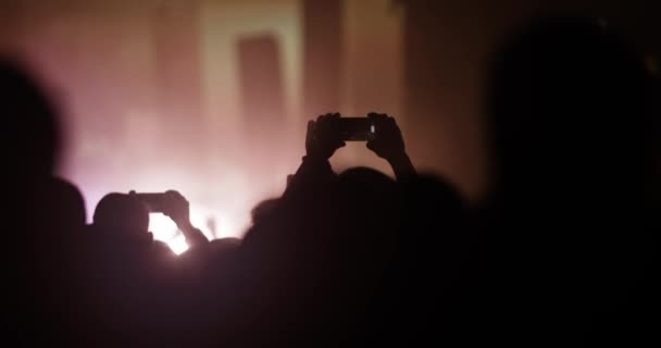 Abstract Silhouette People Crowd Hands Dancing Holding Smart Phones Flashes — Vídeo de stock