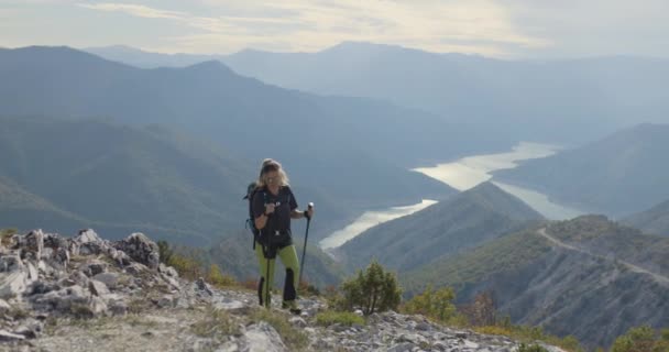 Active Girl Hiking Poles Backpack Walking Uphill View River Lake — Video