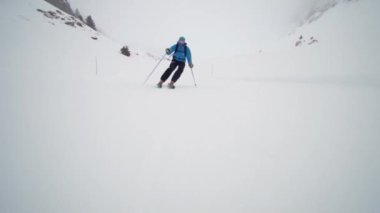 Professional skier extreme fast skiing in the dusk of the day. Empty slopes.