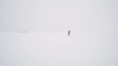 Professional skier extreme fast skiing in the dusk of the day. Empty slopes.