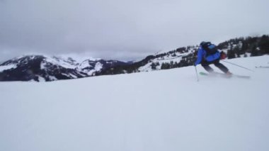 Professional skier extreme fast skiing in the dusk of the day. Empty slopes.