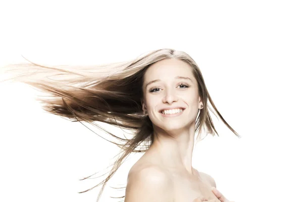 brunette girl with flowing hair in the air studio portrait against white background.