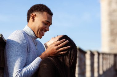 Multiracial couple on the walls of an old fortress. Man and woman in love.