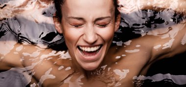 Underwater beauty portrait of a beautiful caucasian girl. Looking at camera.