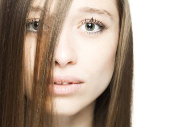 Kameraya bakarak mutlu bir yüz ifadesi olan güzel esmer bir kızın stüdyo portresini kapat..