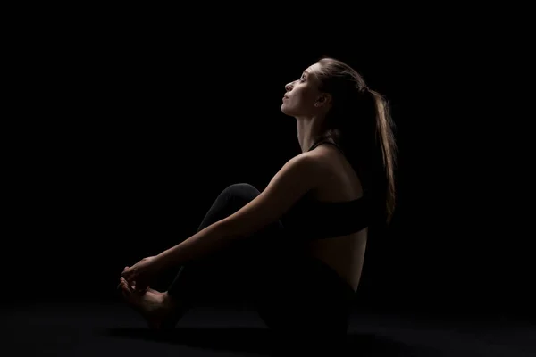 Cute Caucasian Girl Relaxing Yoga Exercise Dark Backgroung Side Lit — Stok fotoğraf