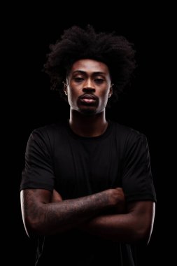 Serious concentrated african american man against dark background.