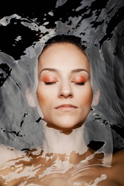 Underwater beauty portrait of a beautiful caucasian girl. Eyes closed.