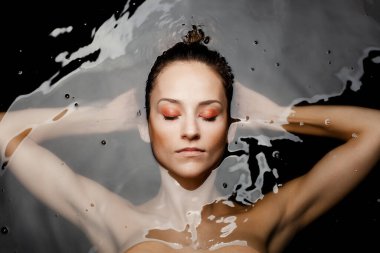 Underwater beauty portrait of a beautiful caucasian girl. Eyes closed.