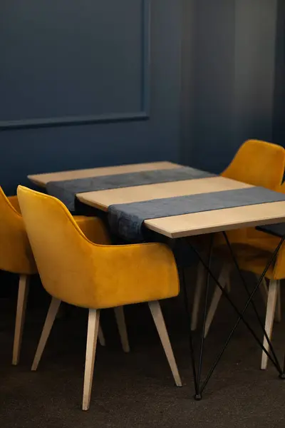 Contemporary Cafe Setting Featuring Golden Yellow Chairs Blue Walls Chic Fotos de stock libres de derechos