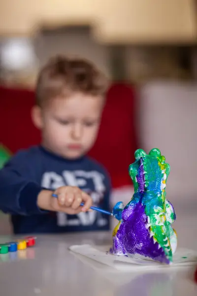 Close Image Young Boy Deeply Engaged Painting Dinosaur Model Uses Stockbild