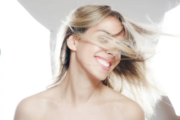 Joyful Woman Flowing Blonde Hair Smiles Broadly Bright Studio Her Stockbild