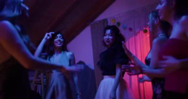 Arkadaşlar birlikte dans eder ve ev partisinden zevk alırlar. Mutlular ve kutluyorlar..