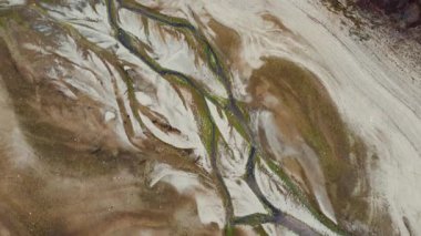 Aerial view of Mavrovos dry lake bed, showcasing unique textures and patterns formed by nature. The video captures the beauty of a dried-up lake.