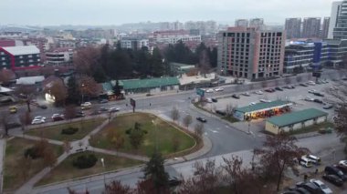 Aerial view of Cveten Pazar in Kapishtec, Skopje, North Macedonia. Cars parked, buildings, and a cloudy sky.