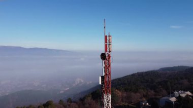 Telecommunication tower with antennas against a blue sky, capturing the essence of connectivity and communication in the digital age.
