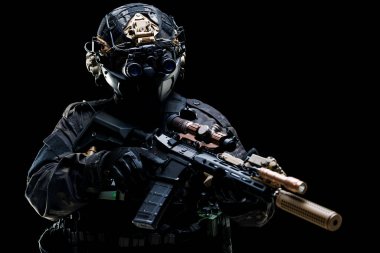 Tactical operator in advanced combat gear, holding a rifle, displays focus and readiness in a dynamic pose with a black background, showcasing concepts of bravery, strategy, and military expertise.