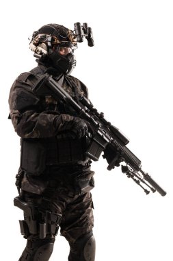 Special forces unit fully geared in tactical attire holding weaponry, showcasing special operations readiness, and emphasizing precision and professionalism in a controlled isolated environment on a