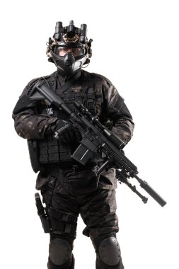 A soldier wearing tactical armor with night vision equipment holding a modern firearm. The gear includes protective clothing and advanced equipment, symbolizing readiness and expertise in security or