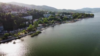 Scenic aerial view of Lake Dojran in North Macedonia, with its tranquil waters, lush greenery, and charming coastal town of Star Dojran.