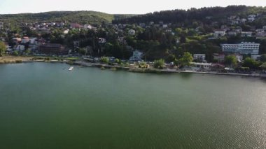 Lake Dojran in North Macedonia on a summer afternoon. A serene view of Star Dojran with clear water and green hills.