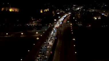 Traffic jam on Goce Delcev bridge in Skopje, North Macedonia during evening rush hour. Aerial night view.