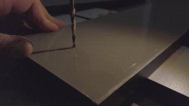 Hand drill making hole in an mdf board. DIY home project.