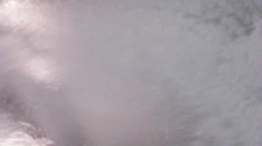 Bubbles and sprays fill the air as the car wash machine cleans the vehicle with colorful suds. The lively atmosphere is enhanced by bright lights and cheerful sounds.