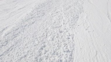 Stunning mountain landscape with fresh snow and a chairlift on a clear, sunny day.