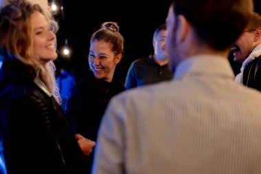 Friends gathered together share smiles and laughter in an engaging atmosphere, capturing the spirit of friendship, joy, and connectivity.