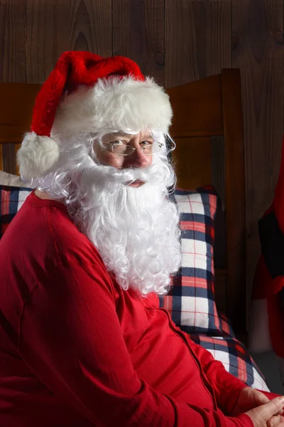 Closeup Santa Claus Sitting His Bed Rustic Cabin Setting Wearing — Stock Photo, Image