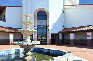 SANTA ANA, CALIFORNIA - 1 FEB 2023: Fountain and entrance to the Santa Ana Regional Transportation Center. clipart