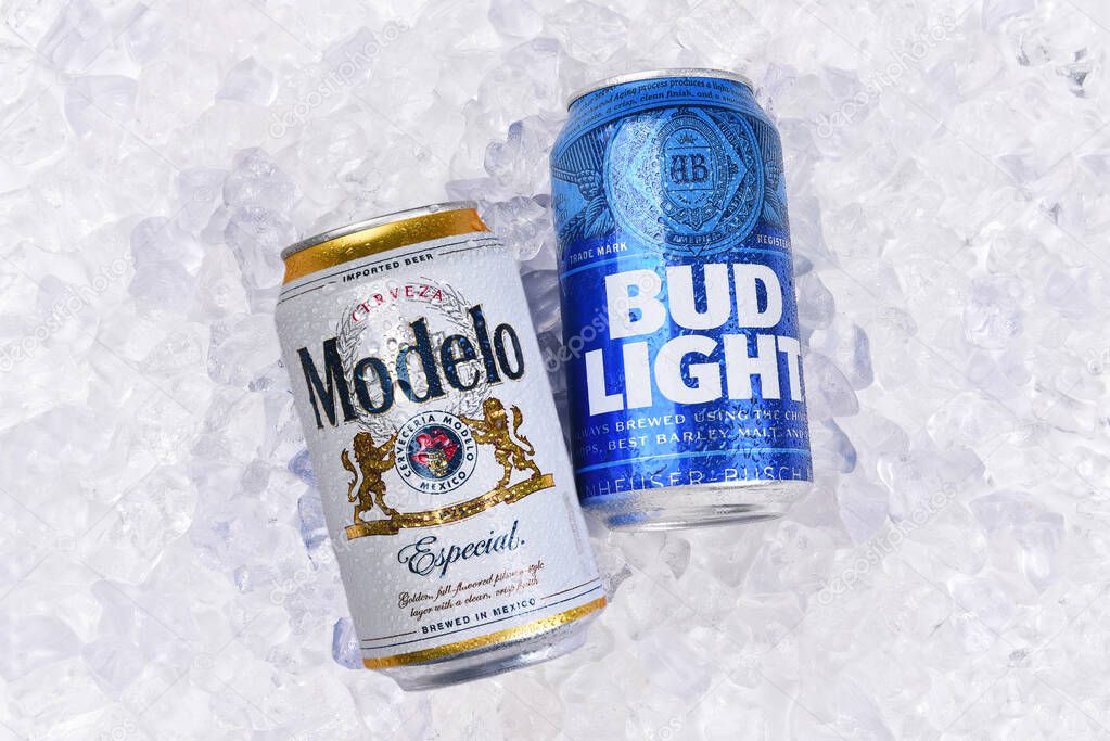 IRVINE, CALIFORNIA - 15 JUN 2023: A can of Modelo Especial and A can of Bud Light on Ice. The two brands battle for the Number 1 spot in USA Sales.