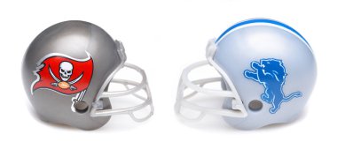 IRVINE, CALIFORNIA - 18 Jan 2024: Football helmets of the Tampa Bay Buccaneers and the Detroit Lions opponents in the Divisional Round of the playoffs. clipart