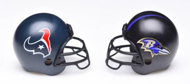 IRVINE, CALIFORNIA - 18 JAN 2024: Helmets for the Houston Texans and Baltimore Ravens opponents in the NFL Divisional Playoff Round. clipart