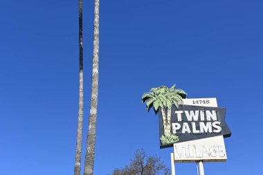 WHITTIER, CALIFORNIA - 28 APR 2024: Twin Palms Village sign at the retro strip mall on Whittier Boulevard. clipart