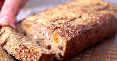 Woman baker and confectioner serve up freshly baked homemade sweet cake or healthy gluten free easter bread with fruits and nuts 4k video