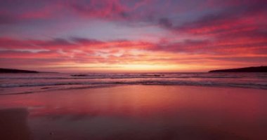 Tropical sunrise on the beach shore. Sunset over the ocean and seascape, 4K relaxing video