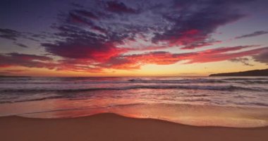 Burning red sky and color sunrise over tropical island beach and caribbean sea shore, cinematic video in 4k 