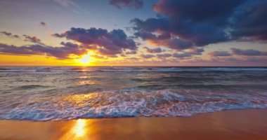 Morning relaxation on the sea shore. Sunrise over ocean waves and beach 4k video
