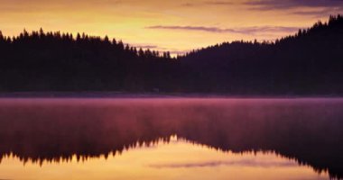 Morning fog on the lake at sunrise. Shiroka polyana dam and beautiful spectacular aerial view of forest and water.