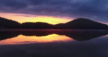 Morning fog on the lake at sunrise. Shiroka polyana dam and beautiful spectacular aerial view of forest and water.