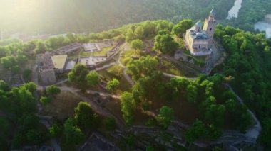 Aerial sunrise view of Tsarevets Fortress in Veliko Tarnovo city in a beautiful summer day, Bulgaria nature and history, 4k aerial video