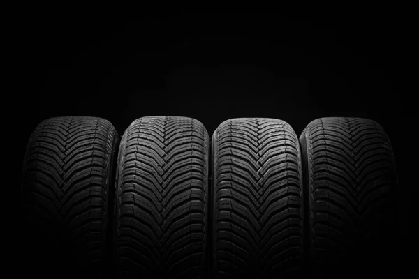 Car tires, winter wheels isolated on black background, transport transportation business industry
