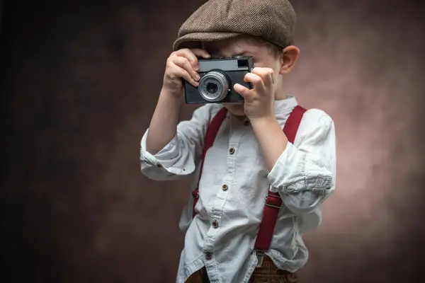 stock image Boy Photographer with Retro Camera making picture against vintage background