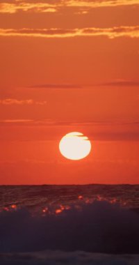 Deniz ufkunun üzerinde bulutlar ve uçan martılar, okyanus yaz gündoğumu manzarası gökyüzünde özgürlük kuşları dikey görünüm