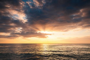 Deniz ufkunda ve sahilde güzel bir gün doğumu, güzel deniz manzarası.